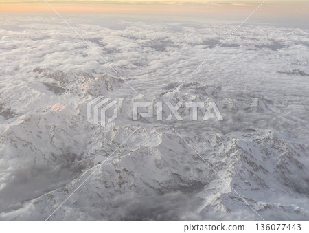 Remote icy mountain range with clear cold atmosphere emphasizing untouched natural wilderness 136077443