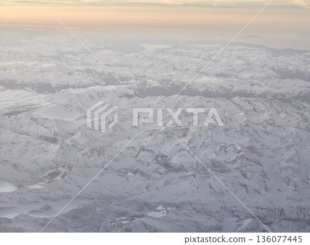 Snowy ridges and valleys, Majestic winter scene with expansive aerial views and textured snowfields 136077445