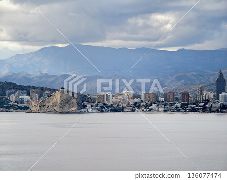 Tranquil ocean with mountain background, Serene seascape featuring broad shoreline and mountain scenery Tranquil ocean with mountain background, Serene seascape featuring broad shoreline and mountain scenery 136077474