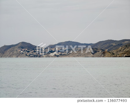 Quiet harbor surrounded by hills, Peaceful community nestled among rolling hills and rugged coastlines 136077493