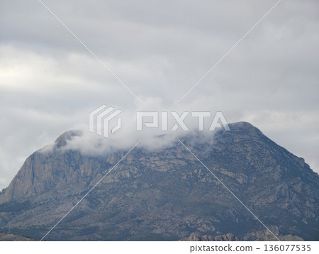 Mystic mountain scene, Calm natural landscape featuring mistcovered volcanic dome and lush surroundings Mystic mountain scene, Calm natural landscape featuring mistcovered volcanic dome and lush surroundings 136077535