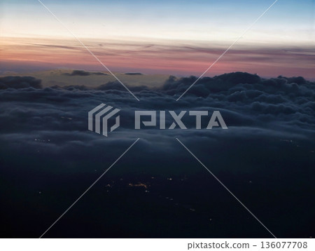 Calm twilight sky above distant cityscape, Atmospheric scene of fading light and peaceful horizon view 136077708