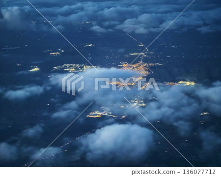 Bright city lights outshine fog, Colorful city illumination exceeds dimness of cloudy atmospheric views Bright city lights outshine fog, Colorful city illumination exceeds dimness of cloudy atmospheric views 136077712