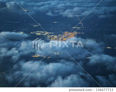 Dark ocean backdrop with shimmering harbor and distant pathways evoke solitude and cautious optimism Dark ocean backdrop with shimmering harbor and distant pathways evoke solitude and cautious optimism 136077713