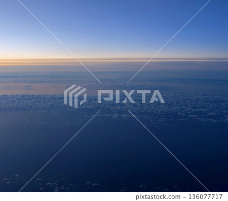 Dawn sky with gentle hues, Tranquil morning scene featuring sparse clouds and expansive sky view 136077717