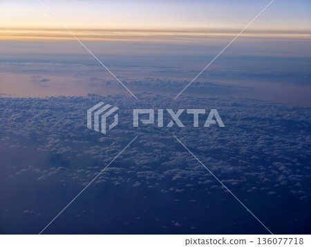 Broad cloud formation extends towards horizon with subtle twilight hues and surface details Broad cloud formation extends towards horizon with subtle twilight hues and surface details 136077718