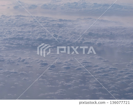 High altitude perspective capturing soft pastel hued clouds extending across vast ocean depths High altitude perspective capturing soft pastel hued clouds extending across vast ocean depths 136077721