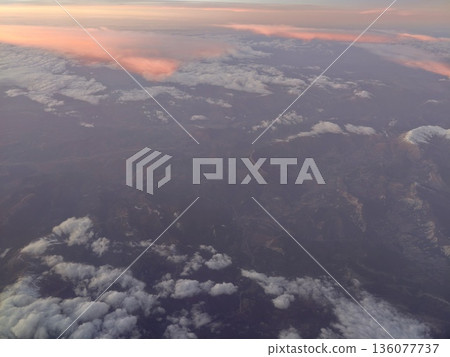 Snowcapped peaks in dawn light, Early morning rays cast glow over rugged alpine ridges and snow lines 136077737