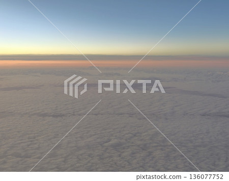 Early morning aerial view showcasing gentle glow and expansive cloud cover in tranquil setting Early morning aerial view showcasing gentle glow and expansive cloud cover in tranquil setting 136077752