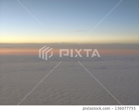 Peaceful early morning sky featuring minimal golden bands and serene cloud formations perfect for inspiration 136077755