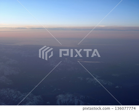 Peaceful view over lake at sunset, Tranquil horizon blending sky and water during evening hours 136077774