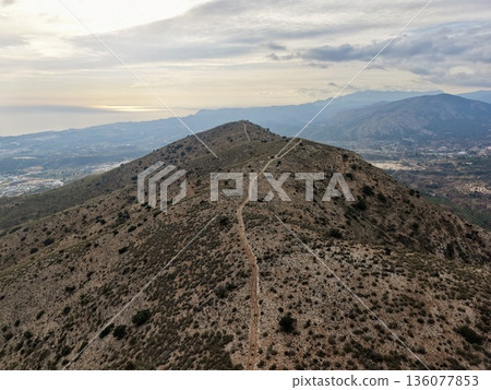 Cliffside path overlooking landscape, High mountain route overlooking ocean and cityscape background 136077853