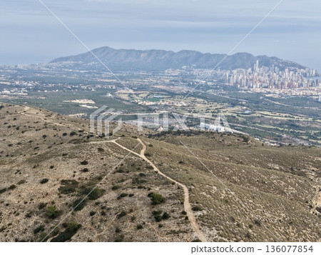 Hiking route guides adventurers past suburban neighborhoods toward expansive coastal scenery Hiking route guides adventurers past suburban neighborhoods toward expansive coastal scenery 136077854