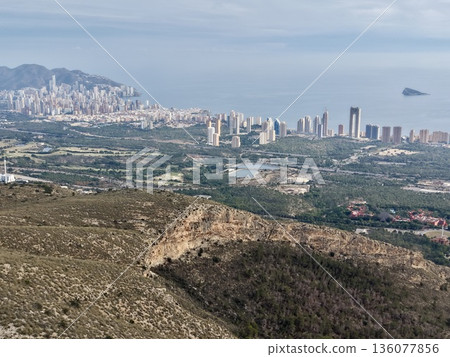 Urban expansion with scenic horizon, Developing residential areas along shoreline with distant hills Urban expansion with scenic horizon, Developing residential areas along shoreline with distant hills 136077856