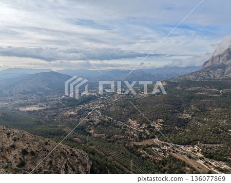 Mountain valley view, Scattered villages and peaks, Serene landscape with roads and orchards Mountain valley view, Scattered villages and peaks, Serene landscape with roads and orchards 136077869