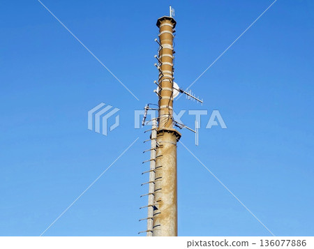 Elevated concrete skyscraper with numerous cellular units and safety features displayed prominently 136077886
