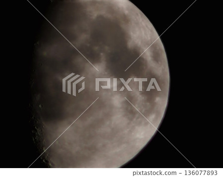 Closeup shot of waxing moon illustrates deep shadows and rugged landscape in stark contrast Closeup shot of waxing moon illustrates deep shadows and rugged landscape in stark contrast 136077893