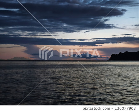 Peaceful bay under twilight sky, Silent harbor at dusk showcasing gentle waves and distant mountains Peaceful bay under twilight sky, Silent harbor at dusk showcasing gentle waves and distant mountains 136077908