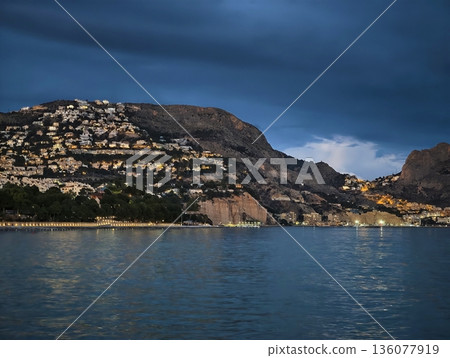 Dark clouds forecast, Storm clouds swirl above shimmering bay as sailor carefully maps secure route 136077919