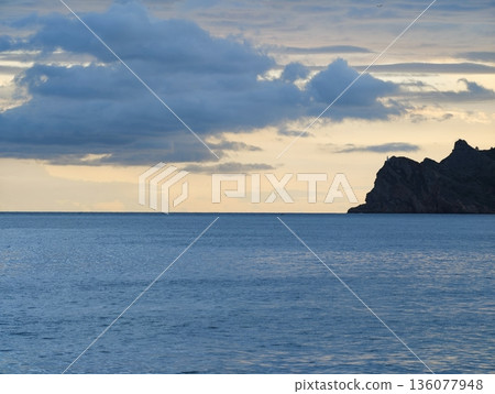 Gentle dawn over calm waters, Serene morning view featuring tranquil water and distant landforms Gentle dawn over calm waters, Serene morning view featuring tranquil water and distant landforms 136077948