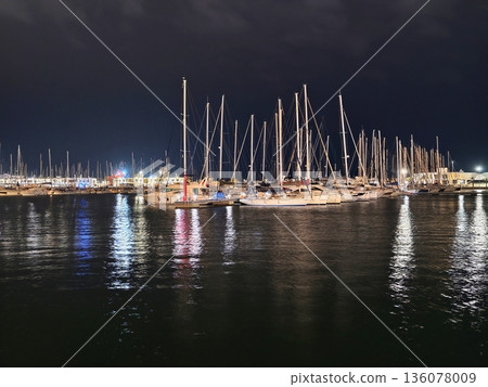 Vibrant harbor nightlife, Colorful harbor at night with lively reflections and illuminated ships 136078009