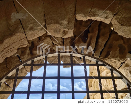Sky visible through window, Open exterior contrasted with enclosed interior through ornate window frame 136078033