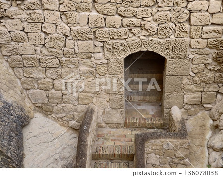Historic stone stairs and mossy walls, Weathered entrance with mosscovered stones and shadowed cellar Historic stone stairs and mossy walls, Weathered entrance with mosscovered stones and shadowed cellar 136078038