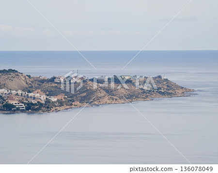 Peaceful coastal area for relaxation, Calm promontory featuring scattered houses and tranquil ocean views 136078049