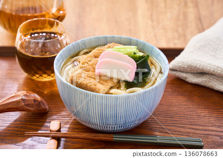 Kitsune udon noodles served with large fried tofu and kamaboko fish cake Kitsune udon noodles served with large fried tofu and kamaboko fish cake 136078663
