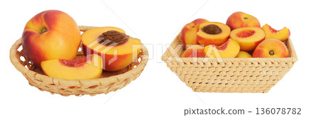 Ripe nectarine fruit with half in a wicker basket isolated on white background with full depth of field 136078782