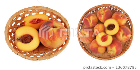 Ripe peach fruit with half in a wicker basket isolated on white background with full depth of field. Top view. Flat lay Ripe peach fruit with half in a wicker basket isolated on white background with full depth of field. Top view. Flat lay 136078783