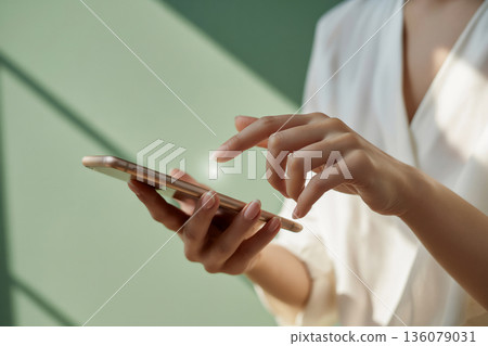 Woman's hand operating a smartphone Generative AI Woman's hand operating a smartphone Generative AI 136079031