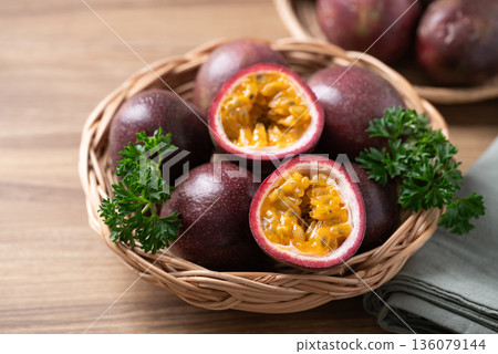 Fresh passion fruit in basket on wooden background, Tropical fruit Fresh passion fruit in basket on wooden background, Tropical fruit 136079144