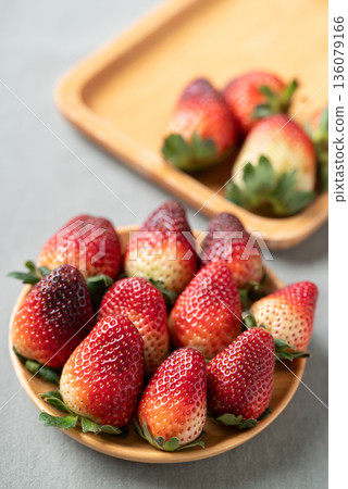 Fresh organic strawberry with green leaf on wooden plate over fabric background, Healthy eating Fresh organic strawberry with green leaf on wooden plate over fabric background, Healthy eating 136079166