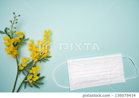 Product photography of mimosa flowers and white masks 136079434