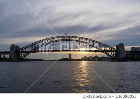Sydney Harbour Bridge at sunset with golden reflections on the water Sydney Harbour Bridge at sunset with golden reflections on the water 136080053