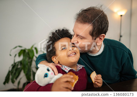 Loving father kissing happy son expressing bond at home 136080173
