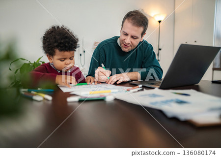 Father and son coloring together at home Father and son coloring together at home 136080174