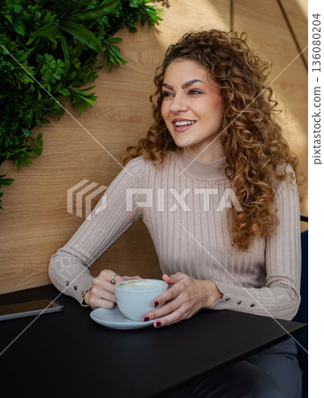 Young woman enjoying coffee moments in a cafe 136080204