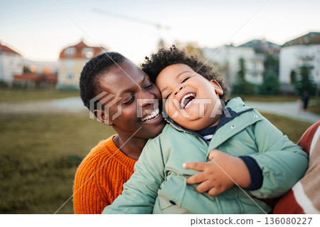 Mother and son laughing and bonding outdoors Mother and son laughing and bonding outdoors 136080227