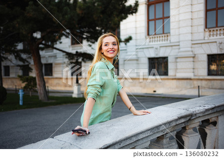 Young woman smiling while exploring a historical building in Vienna Young woman smiling while exploring a historical building in Vienna 136080232