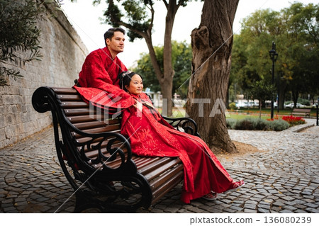 Mixed couple celebrating wedding day in traditional Chinese clothing 136080239