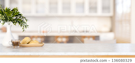 Breads on plate with a cup of coffee aside plant vase on marble cooking counter in a modern kitchen. 136080329