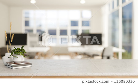 Books aside potted plant and vase on marble table in across computer tables in office or classroom. Books aside potted plant and vase on marble table in across computer tables in office or classroom. 136080330
