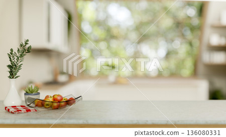 Apples in glass plate with dish cloth aside potted plant on marble cooking counter in modern kitchen Apples in glass plate with dish cloth aside potted plant on marble cooking counter in modern kitchen 136080331