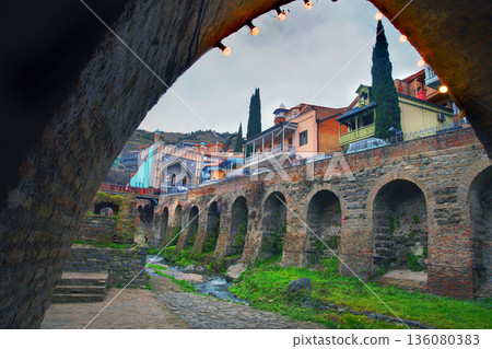 Abanotubani with sulphur bathhouses and Minaret of mosque 136080383