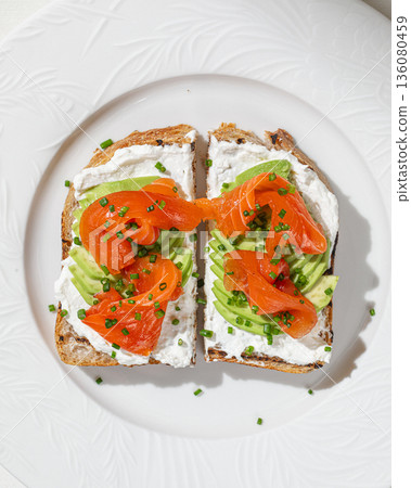 Toast with smoked salmon avocado and cream cheese 136080459