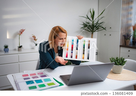 Woman showing color palette during online video call meeting 136081409