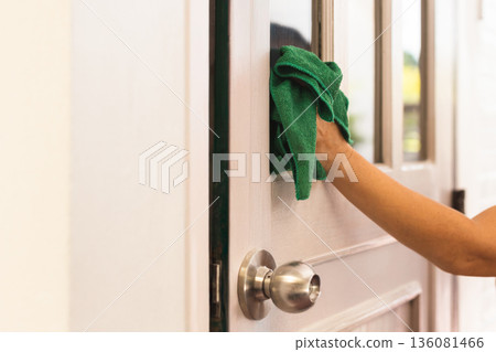 Hand cleaning glass door window at home. Hand cleaning glass door window at home. 136081466