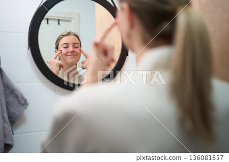 A Gentle Pause While Applying Eye Patches 136081857